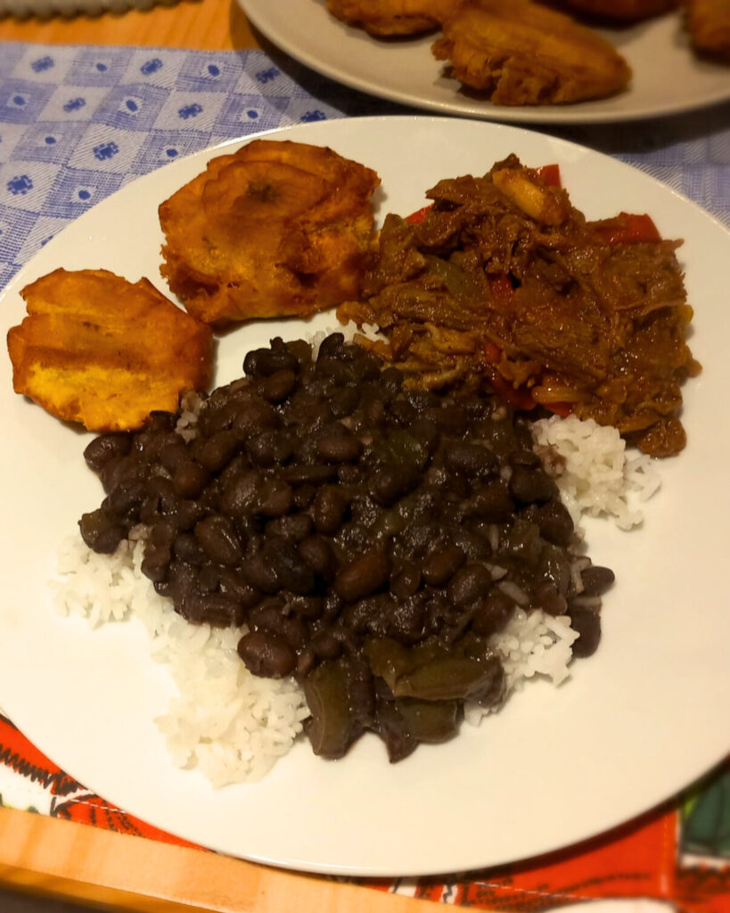 cuban black beans soup served with rice, tostones and ropa vieja