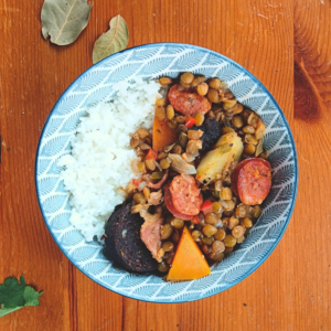 brown lentil soup served on a bowl with rice